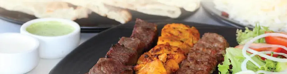 Sheek kebab, chicken tikka and lamb tikka with salad and mint sauce